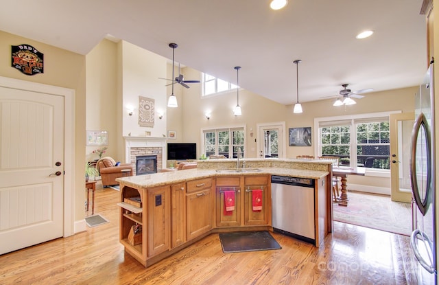 35 Village Pointe Ln, Asheville, NC 28803 - kitchen with stainless steel appliances, a ceiling fan, light wood-style flooring, a stone fireplace, and recessed lighting