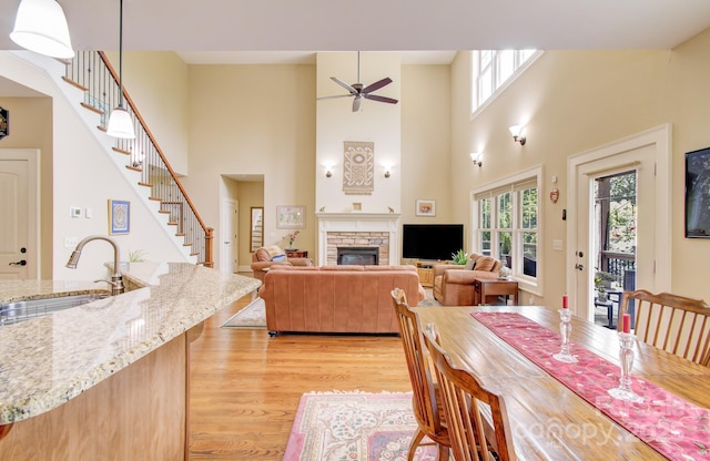 35 Village Pointe Ln, Asheville, NC 28803 - dining area featuring plenty of natural light, light wood-type flooring, a ceiling fan, stairs, and a towering ceiling