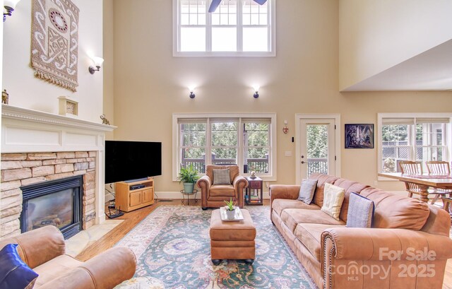 35 Village Pointe Ln, Asheville, NC 28803 - living area with a fireplace, a high ceiling, healthy amount of natural light, wood finished floors, and ceiling fan