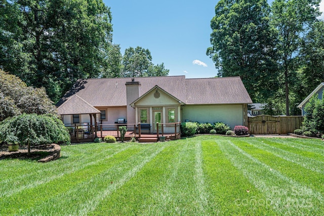 3889 Mattingly Dr, Hickory, NC 28602 - back of property with a deck, a gate, stucco siding, and a chimney