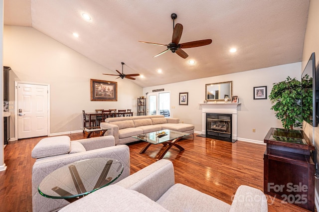 3889 Mattingly Dr, Hickory, NC 28602 - living area featuring a ceiling fan, a glass covered fireplace, wood finished floors, recessed lighting, and high vaulted ceiling