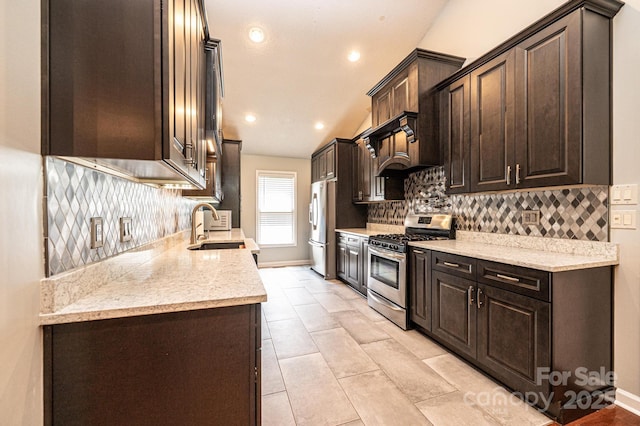 3889 Mattingly Dr, Hickory, NC 28602 - kitchen with stainless steel range with gas stovetop, dark brown cabinets, tasteful backsplash, freestanding refrigerator, and recessed lighting