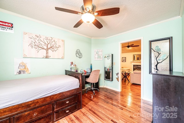 3889 Mattingly Dr, Hickory, NC 28602 - bedroom featuring light wood finished floors, crown molding, a textured ceiling, and a ceiling fan