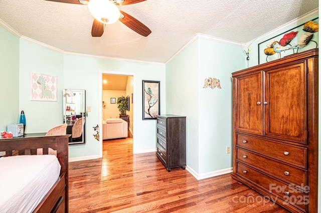 3889 Mattingly Dr, Hickory, NC 28602 - bedroom with ornamental molding, light wood-style flooring, a textured ceiling, and a ceiling fan