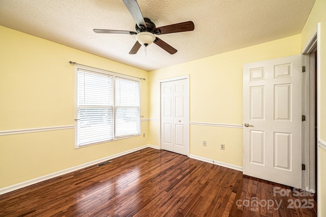 3889 Mattingly Dr, Hickory, NC 28602 - unfurnished bedroom featuring a textured ceiling, dark wood-style floors, a closet, and ceiling fan