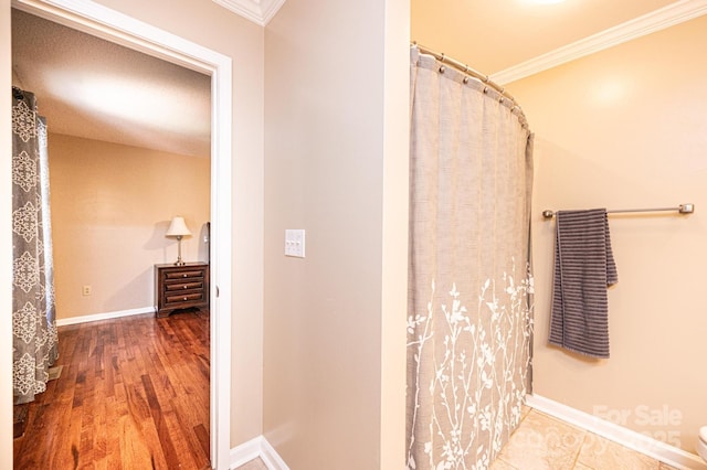 3889 Mattingly Dr, Hickory, NC 28602 - bathroom with ornamental molding, wood finished floors, and a shower with shower curtain