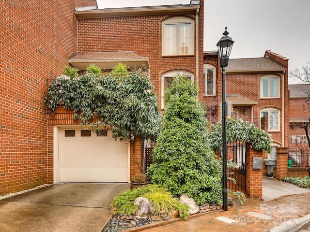 311 Settlers Ln, Charlotte, NC 28202 - view of front of home with concrete driveway, brick siding, and a garage