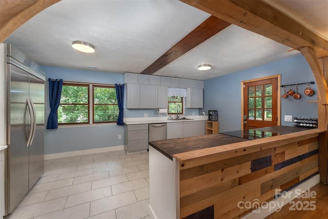 24 Arco Rd, Asheville, NC 28805 - kitchen with stainless steel appliances, gray cabinetry, beamed ceiling, and light tile patterned floors