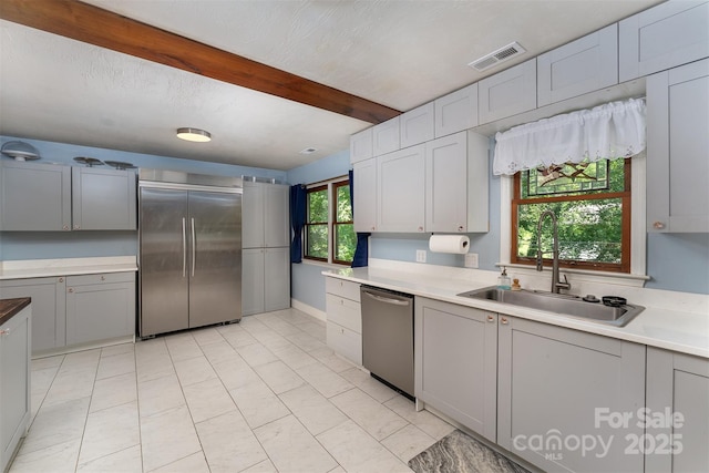 24 Arco Rd, Asheville, NC 28805 - kitchen with stainless steel appliances, gray cabinetry, light countertops, and beam ceiling