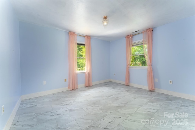 24 Arco Rd, Asheville, NC 28805 - unfurnished room featuring light marble finish flooring and baseboards