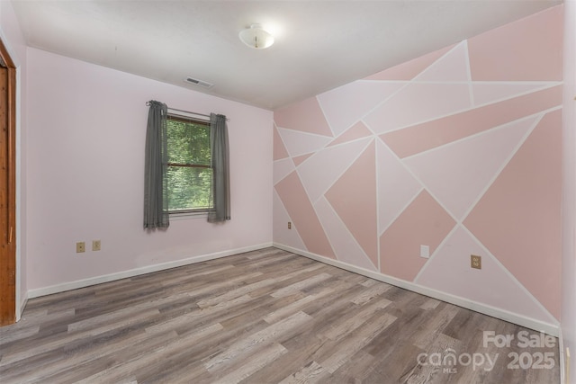 24 Arco Rd, Asheville, NC 28805 - empty room with wood finished floors and baseboards