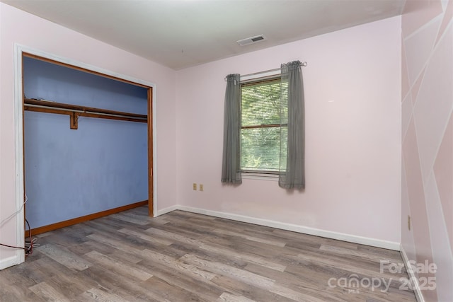 24 Arco Rd, Asheville, NC 28805 - unfurnished bedroom with wood finished floors and a closet