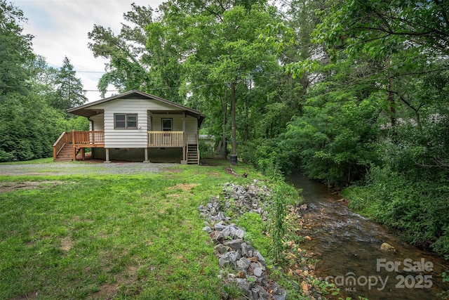 24 Arco Rd, Asheville, NC 28805 - back of house with stairs, crawl space, a lawn, and covered porch