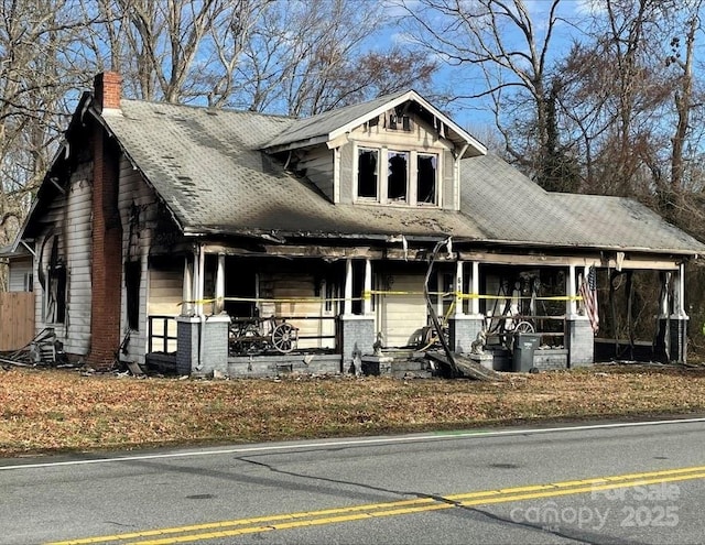 619 N Main St, Landis, NC 28088 - view of front facade with covered porch, a chimney, and brick siding