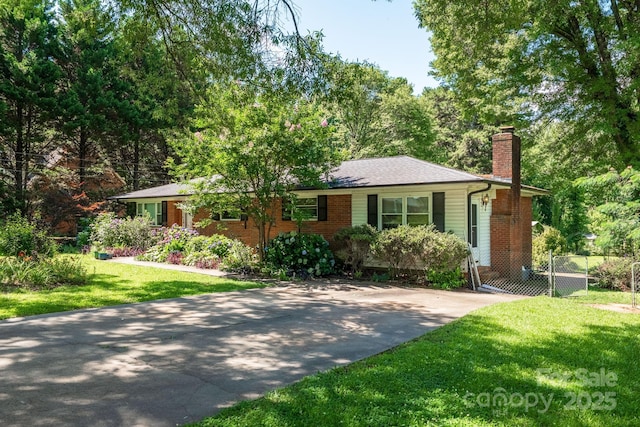 2008 Kimway Dr, Matthews, NC 28105 - ranch-style house featuring a chimney, a front lawn, concrete driveway, and brick siding