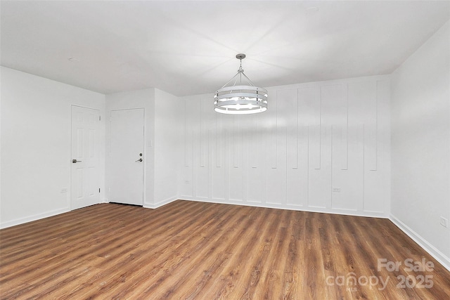 1300 Queens Rd Unit 405, Charlotte, NC 28207 - unfurnished dining area featuring wood finished floors and a chandelier
