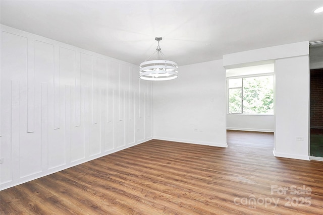 1300 Queens Rd Unit 405, Charlotte, NC 28207 - unfurnished dining area with wood finished floors and a chandelier