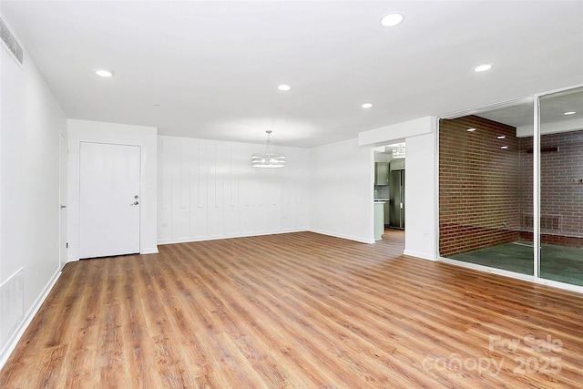 1300 Queens Rd Unit 405, Charlotte, NC 28207 - empty room with light wood-type flooring, a chandelier, and recessed lighting