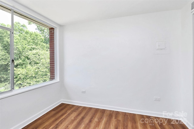 1300 Queens Rd Unit 405, Charlotte, NC 28207 - spare room featuring dark wood-type flooring and baseboards
