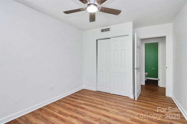 1300 Queens Rd Unit 405, Charlotte, NC 28207 - unfurnished bedroom featuring light wood finished floors, a closet, and a ceiling fan