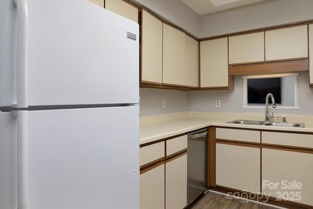 825 21st Ave NE, Hickory, NC 28601 - kitchen featuring freestanding refrigerator, dishwasher, light countertops, cream cabinetry, and wood finished floors