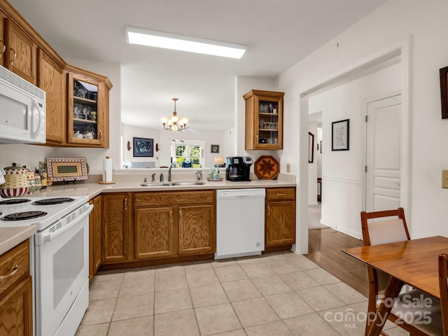 1901 Deermouse Way, Hendersonville, NC 28792 - kitchen with white appliances, brown cabinets, a chandelier, and light countertops