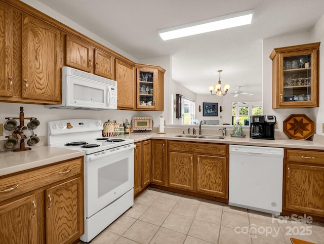 1901 Deermouse Way, Hendersonville, NC 28792 - kitchen with white appliances, brown cabinetry, a chandelier, light tile patterned flooring, and light countertops