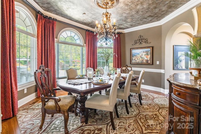572 W Shiloh Unity Rd, Lancaster, SC 29720 - dining room with wood finished floors, a chandelier, and crown molding