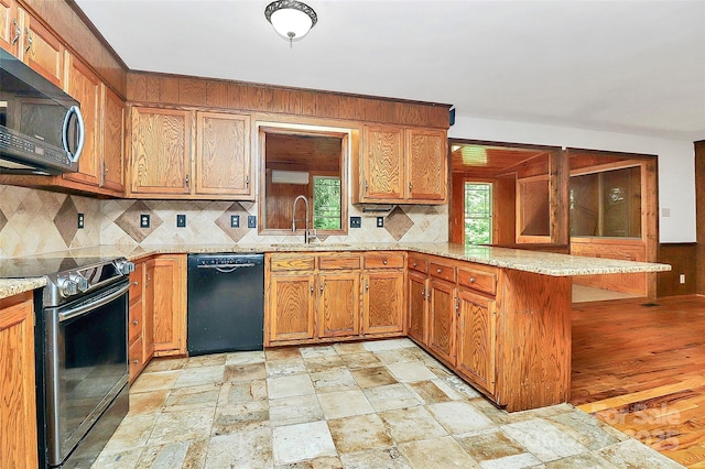 3311 Camden Rd, Marshville, NC 28103 - kitchen with dishwasher, range with electric cooktop, stainless steel microwave, a peninsula, and backsplash