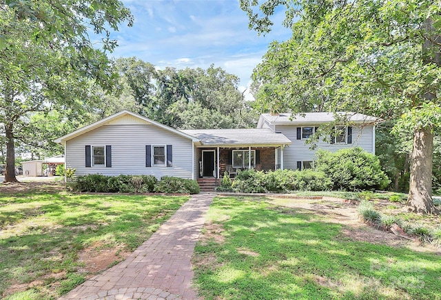 3311 Camden Rd, Marshville, NC 28103 - tri-level home featuring a front lawn, brick siding, and covered porch