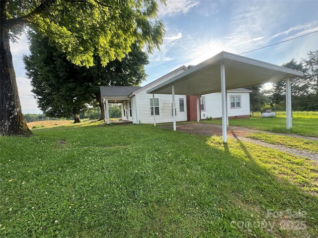 22987 Alonzo Rd, Oakboro, NC 28129 - view of front of house featuring a carport, a front lawn, and asphalt driveway