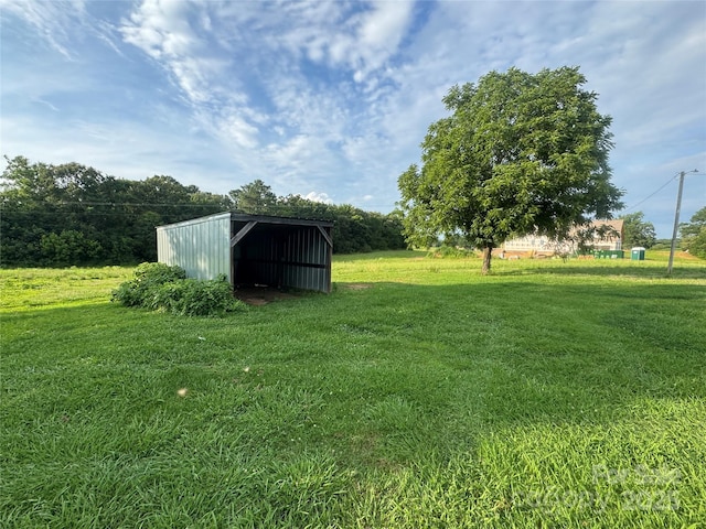 22987 Alonzo Rd, Oakboro, NC 28129 - view of grassy yard with an outbuilding and a detached carport
