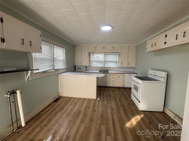 22987 Alonzo Rd, Oakboro, NC 28129 - kitchen featuring white appliances, white cabinets, dark wood-type flooring, and crown molding