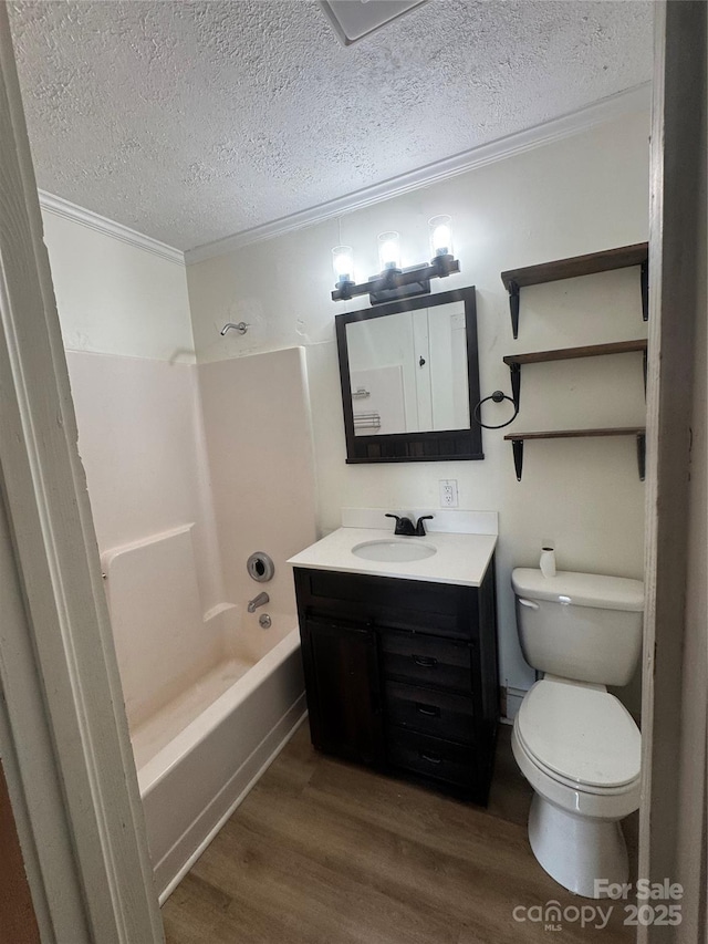 22987 Alonzo Rd, Oakboro, NC 28129 - bathroom with wood finished floors, vanity, bathtub / shower combination, a textured ceiling, and crown molding