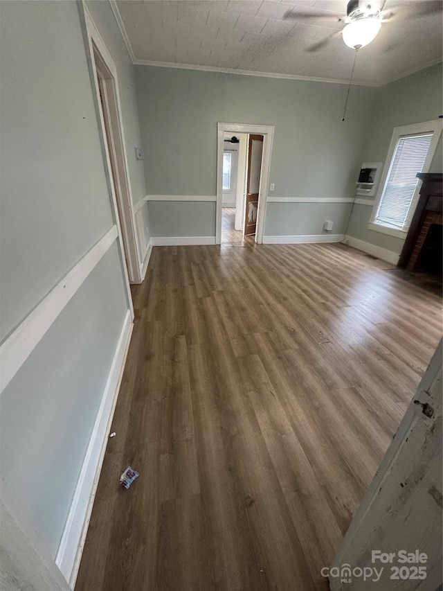 22987 Alonzo Rd, Oakboro, NC 28129 - spare room featuring a ceiling fan, wood finished floors, crown molding, and a brick fireplace