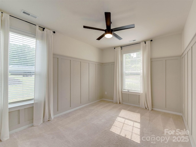 16108 Langston Dr, Charlotte, NC 28278 - unfurnished bedroom featuring a decorative wall, light carpet, a ceiling fan, and wainscoting