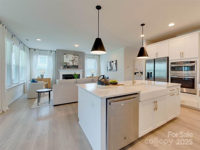16108 Langston Dr, Charlotte, NC 28278 - kitchen with stainless steel appliances, light wood-type flooring, white cabinetry, pendant lighting, and recessed lighting