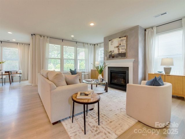 16108 Langston Dr, Charlotte, NC 28278 - living area with a fireplace with flush hearth, light wood-type flooring, and recessed lighting