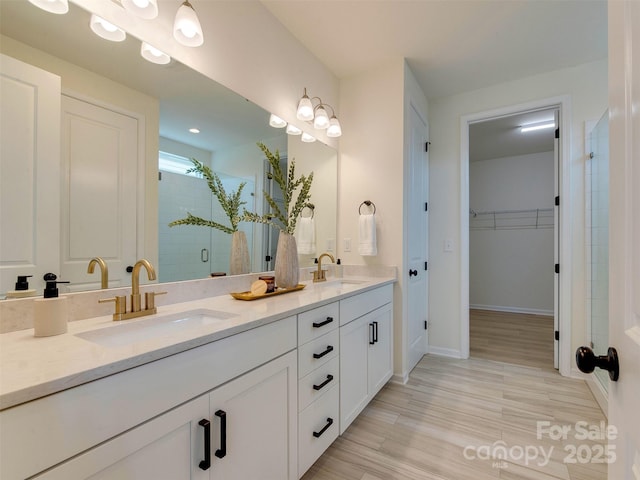 16108 Langston Dr, Charlotte, NC 28278 - full bath featuring double vanity, a stall shower, a spacious closet, and wood finished floors