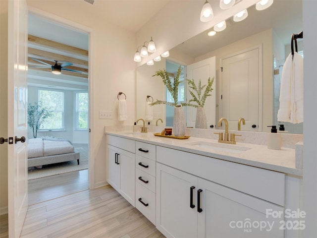 16108 Langston Dr, Charlotte, NC 28278 - ensuite bathroom featuring double vanity, wood finished floors, ceiling fan, and beam ceiling