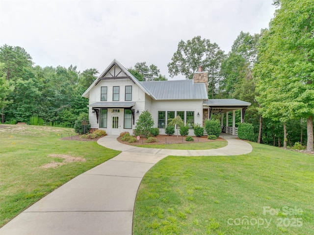 16108 Langston Dr, Charlotte, NC 28278 - modern farmhouse featuring a chimney, a front lawn, a metal roof, and covered porch