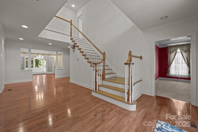 322 Oakview Dr, Salisbury, NC 28146 - stairway featuring crown molding, wood finished floors, recessed lighting, and decorative columns