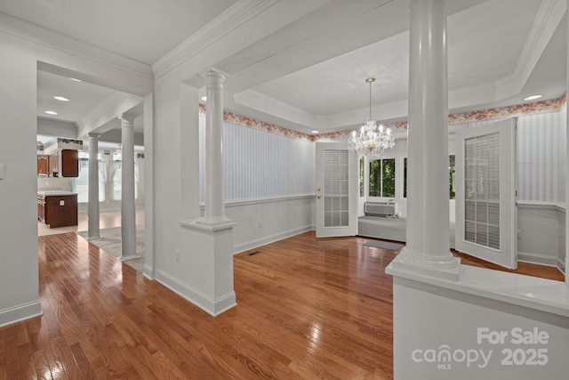 322 Oakview Dr, Salisbury, NC 28146 - unfurnished dining area with decorative columns, wood finished floors, cooling unit, crown molding, and a chandelier