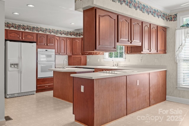 322 Oakview Dr, Salisbury, NC 28146 - kitchen with white appliances, crown molding, light countertops, healthy amount of natural light, and wallpapered walls