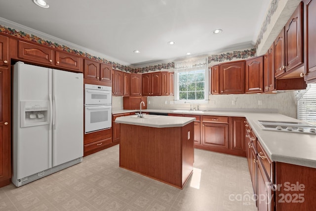 322 Oakview Dr, Salisbury, NC 28146 - kitchen with white appliances, light flooring, light countertops, a kitchen island with sink, and crown molding