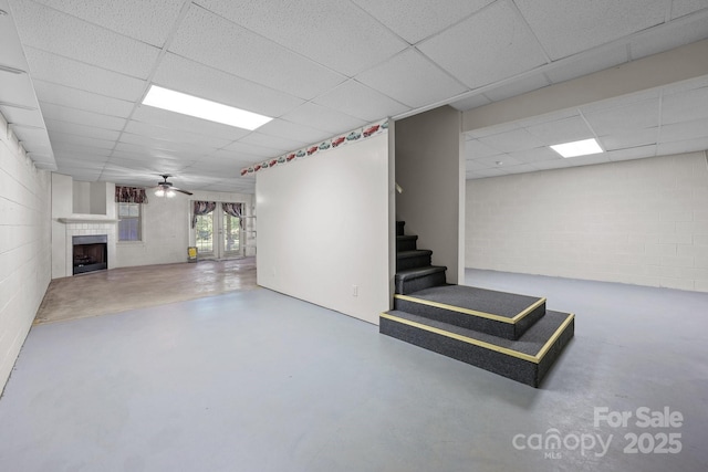 322 Oakview Dr, Salisbury, NC 28146 - below grade area featuring a drop ceiling, stairway, a tiled fireplace, concrete block wall, and ceiling fan