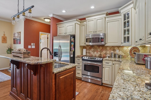 2256 Drawbridge Ct, Rock Hill, SC 29732 - kitchen featuring appliances with stainless steel finishes, cream cabinets, ornamental molding, light wood-type flooring, and glass insert cabinets
