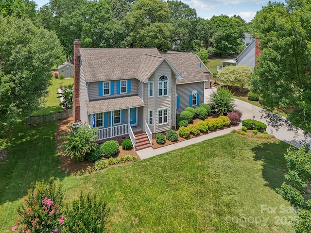 2256 Drawbridge Ct, Rock Hill, SC 29732 - view of front facade with a chimney, a porch, roof with shingles, and view of scattered trees