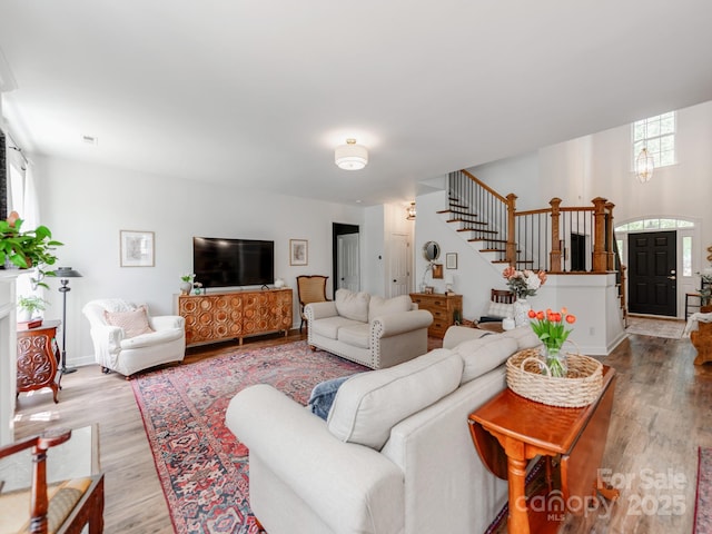 1605 Ambergate Dr, Waxhaw, NC 28173 - living room featuring stairs and light wood-type flooring