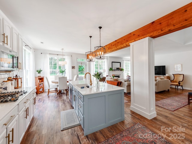 1605 Ambergate Dr, Waxhaw, NC 28173 - kitchen with appliances with stainless steel finishes, open floor plan, white cabinetry, and wood finished floors